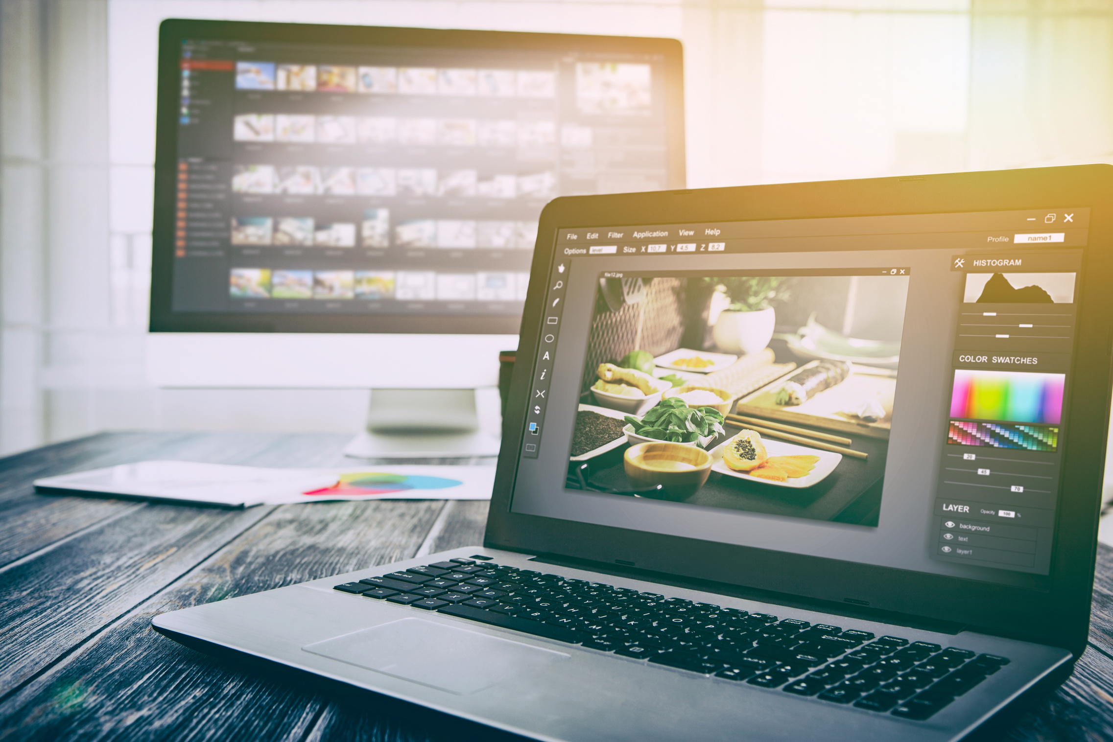 Photographers computer with photo edit programs.